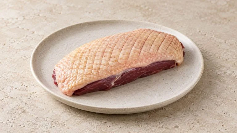 Magret de canard tranché rosé avec peau croustillante, pommes de terre sarladaises et haricots verts